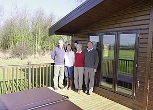 Rupert and Melanie Brown, Margaret and Carl Redfearn on the verandah of a two-bedroom Nordic Pinelodge